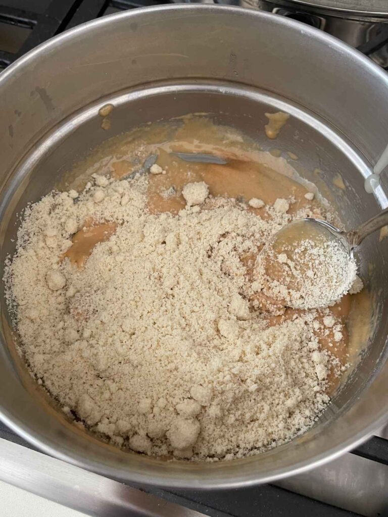 adding the almond flour and collagen to the mixture to create the nougat dough