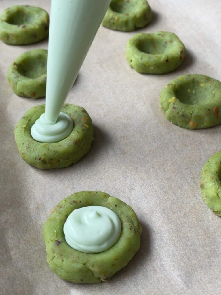 filling being piped into the cookies