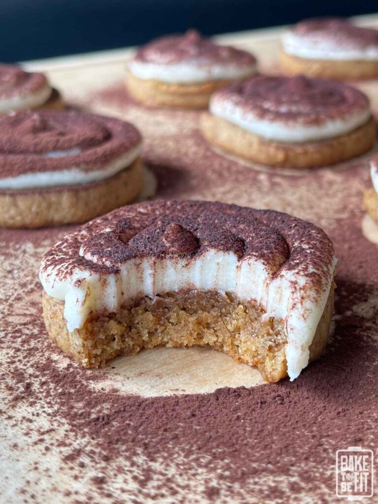 keto tiramisu cookies on parchment paper with a bite taken out