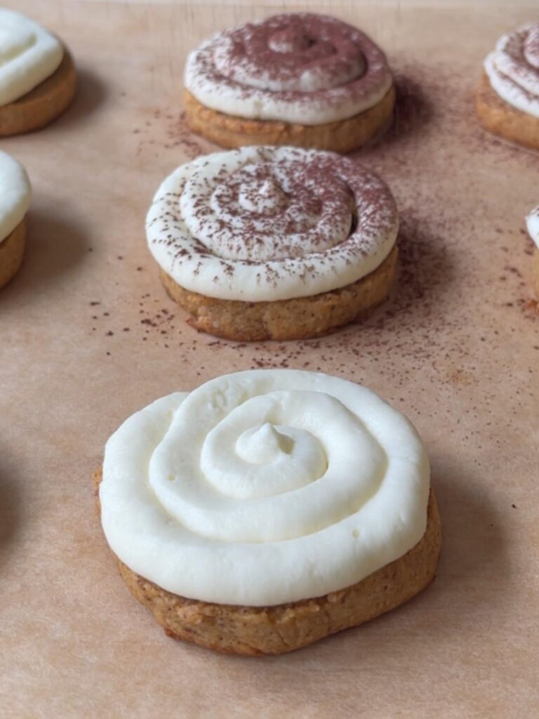 cookies being dusted with cocoa powder