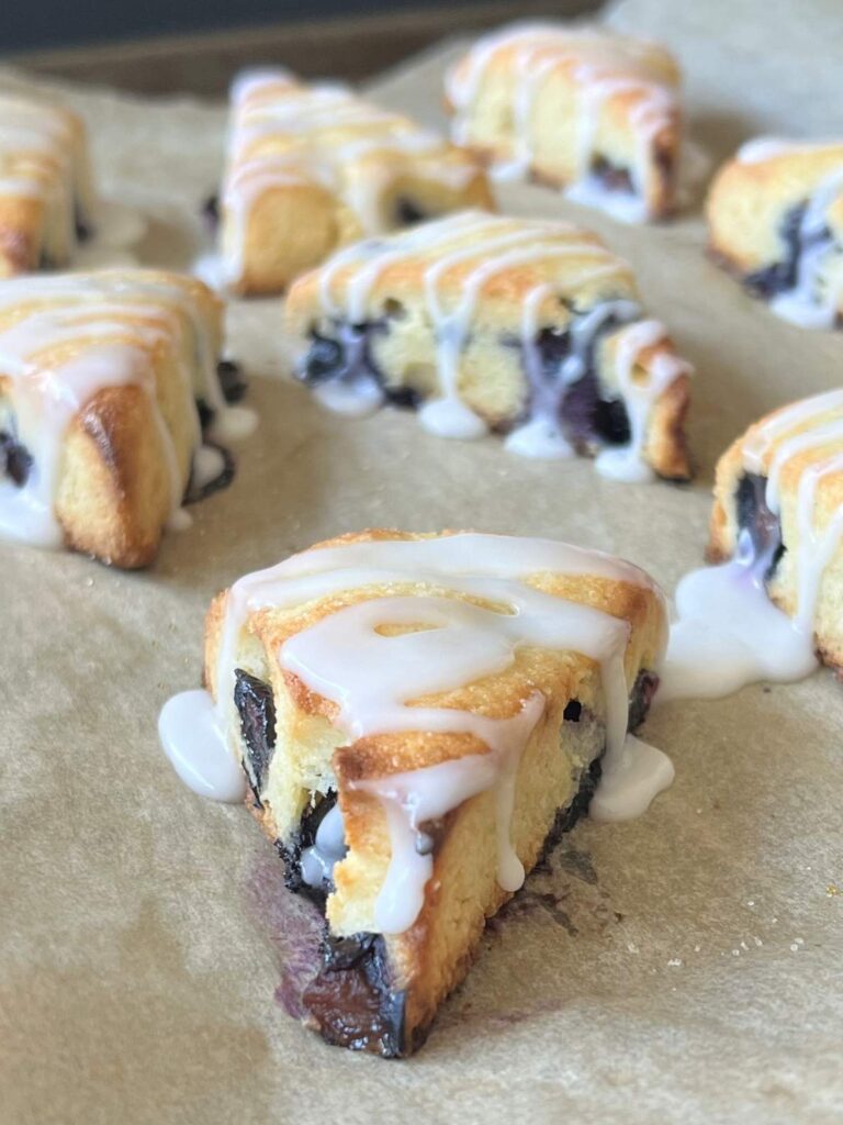 keto blueberry lemon scones on a parchment paper lined tray