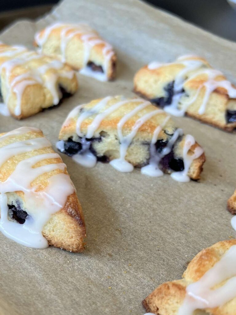 keto blueberry scones with glaze drizzled on top